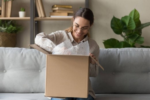 Woman smiling as she goes through a GLS Parcel
